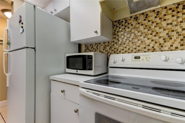 kitchen with decorative backsplash, white cabinets, white appliances, and light tile patterned floors