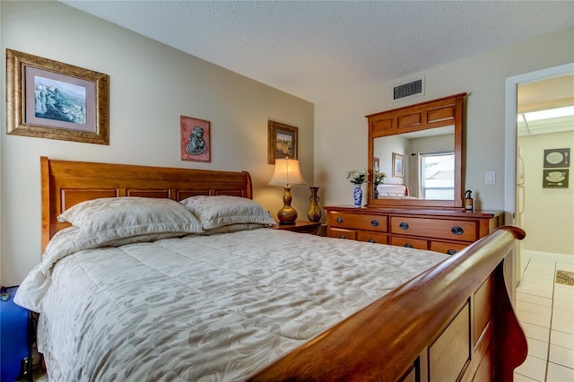 tiled bedroom with a textured ceiling