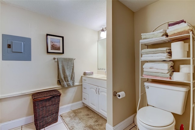 bathroom with vanity, toilet, electric panel, and tile patterned flooring