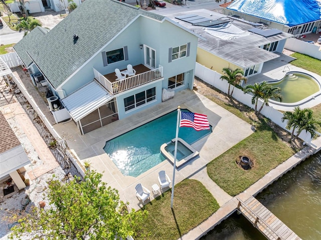 view of pool with a patio and a water view