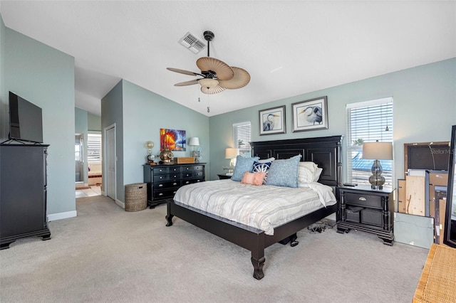 carpeted bedroom with ensuite bath, lofted ceiling, and ceiling fan