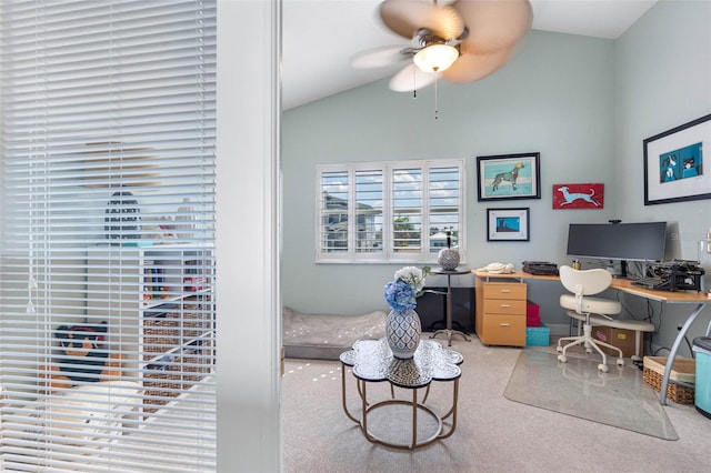 home office featuring lofted ceiling, carpet flooring, and ceiling fan