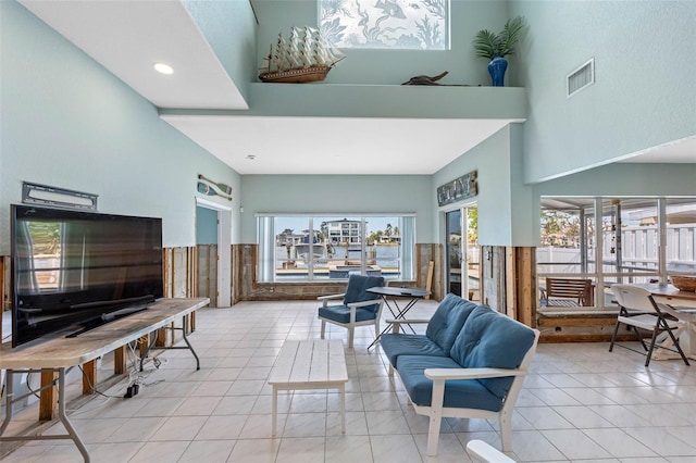 living room featuring a towering ceiling