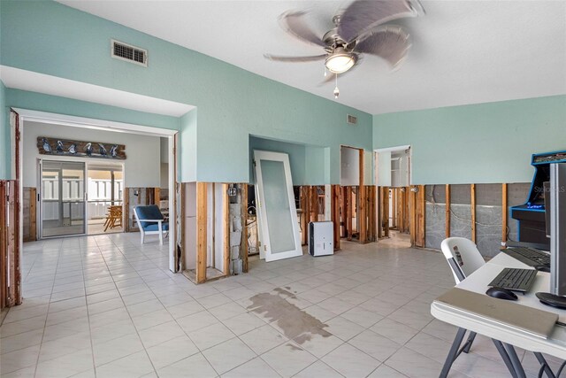 office space featuring light tile patterned flooring, tile walls, and ceiling fan