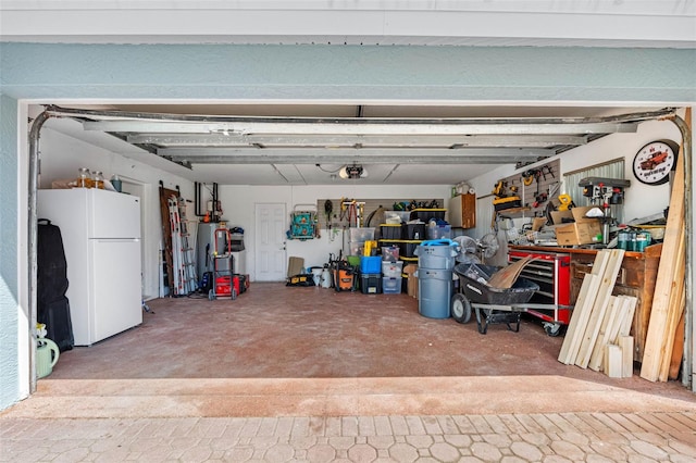 garage with a workshop area and white refrigerator