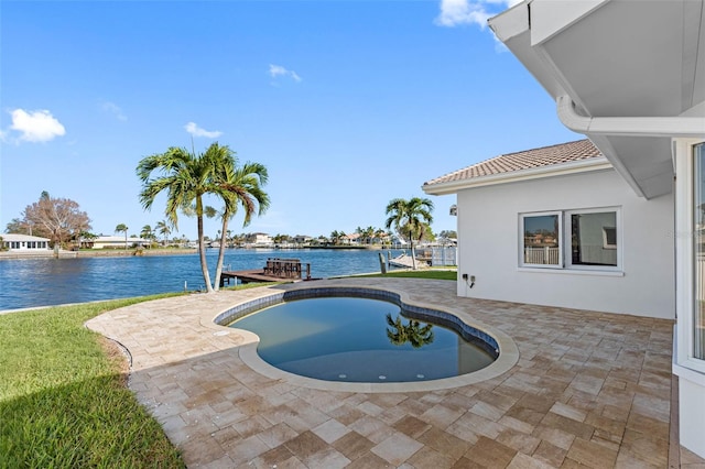 view of swimming pool featuring a water view and a patio area