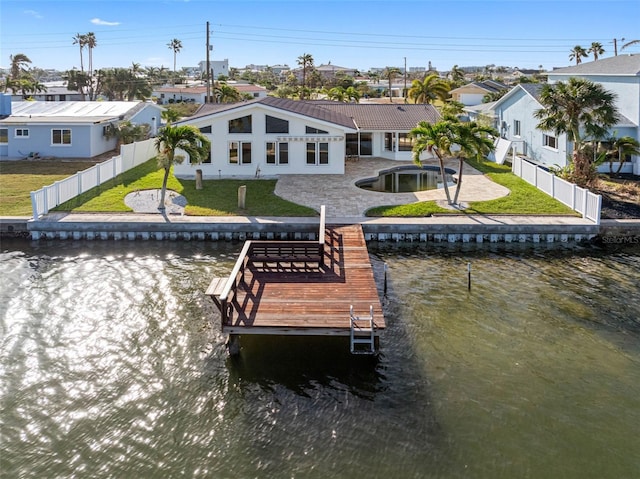 exterior space featuring a yard, a water view, and a patio area