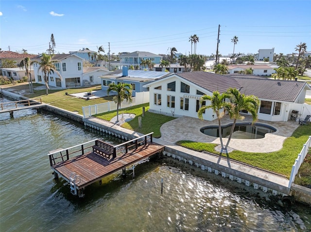 view of dock featuring a patio, a yard, and a water view