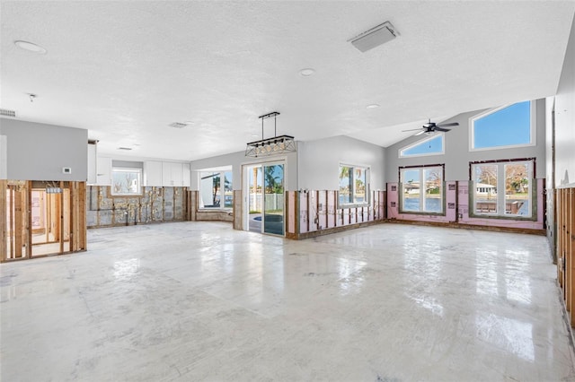 empty room with ceiling fan, a textured ceiling, and lofted ceiling