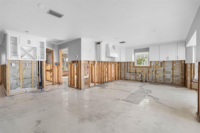 miscellaneous room featuring concrete flooring and a textured ceiling