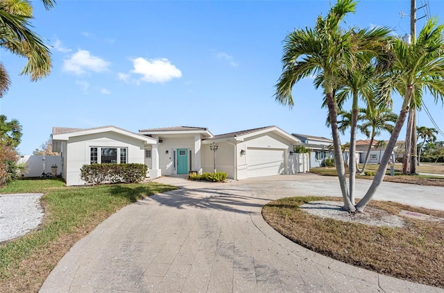 view of front of house featuring a garage and a front lawn