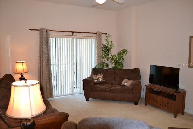 carpeted living room featuring ceiling fan