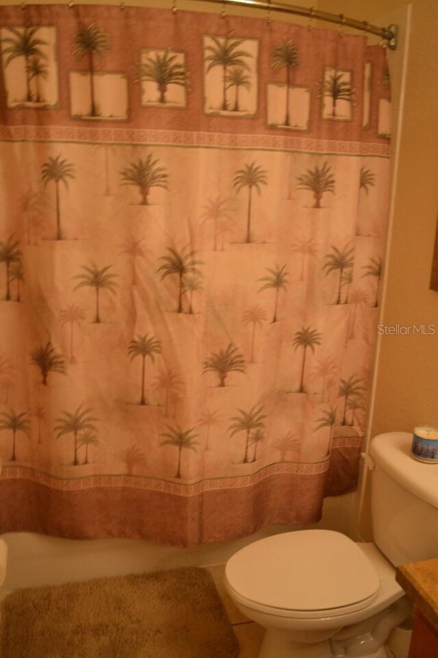 511 Rum Run Unit 33-511, Davenport, FL 33897 - bathroom featuring toilet, vanity, and a shower with curtain