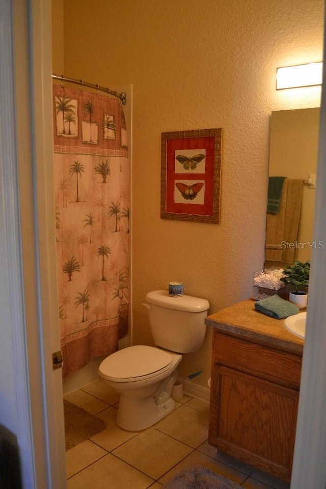 bathroom with vanity, tile patterned floors, and toilet