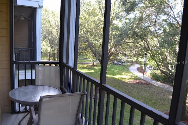 unfurnished sunroom featuring ceiling fan