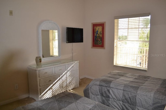 bedroom featuring light carpet