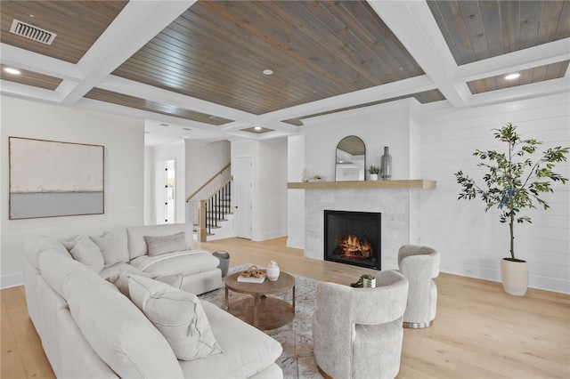 living room featuring coffered ceiling, beam ceiling, and light wood-type flooring