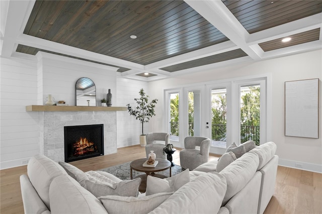 living room featuring coffered ceiling, wood ceiling, light hardwood / wood-style floors, and beamed ceiling