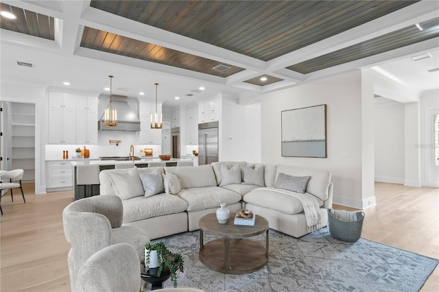 living room featuring beam ceiling, coffered ceiling, and light hardwood / wood-style floors