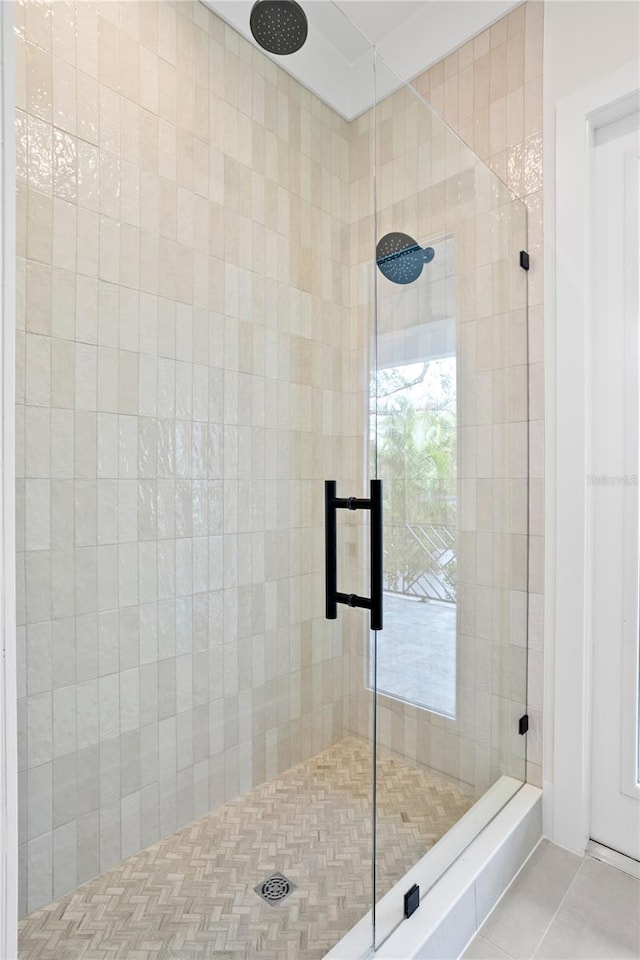 bathroom with tile patterned flooring and walk in shower