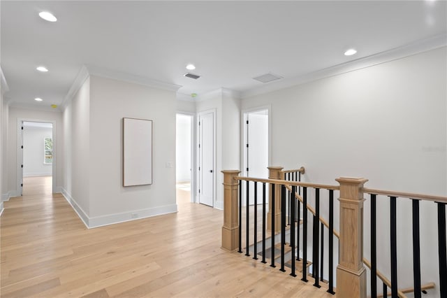 corridor featuring ornamental molding and light hardwood / wood-style floors