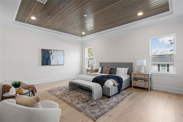 bedroom with a raised ceiling, wooden ceiling, and light wood-type flooring