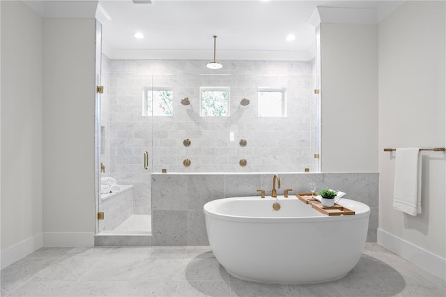 bathroom featuring tile walls, ornamental molding, and independent shower and bath