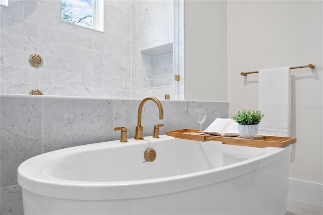 bathroom featuring sink and a washtub