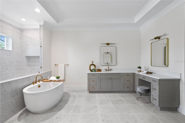 bathroom with ornamental molding, vanity, and a tub