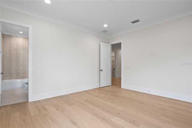 unfurnished room featuring ornamental molding and light hardwood / wood-style floors