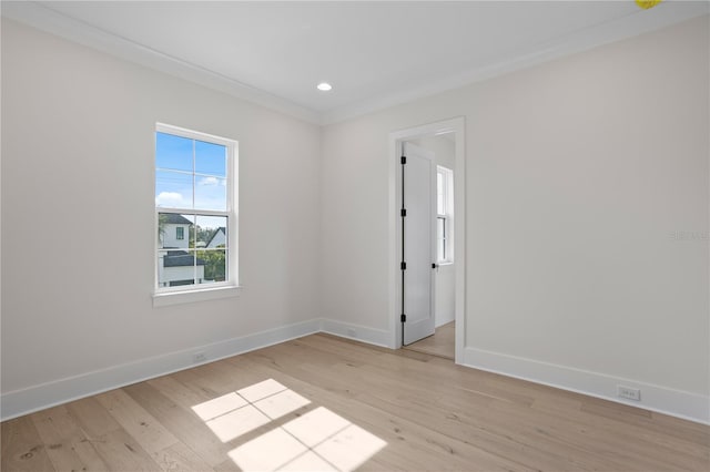 unfurnished room with ornamental molding and light hardwood / wood-style flooring