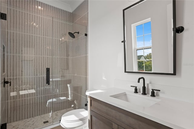 bathroom with vanity, an enclosed shower, and toilet