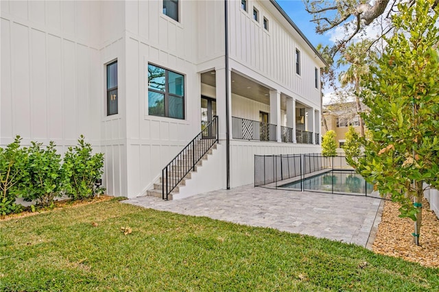 rear view of house with a yard and a patio area