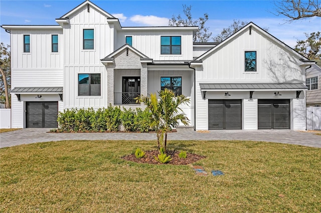 modern farmhouse with a garage and a front lawn