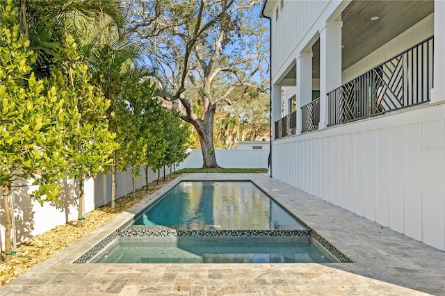 view of swimming pool featuring an in ground hot tub