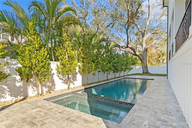 view of swimming pool featuring an in ground hot tub