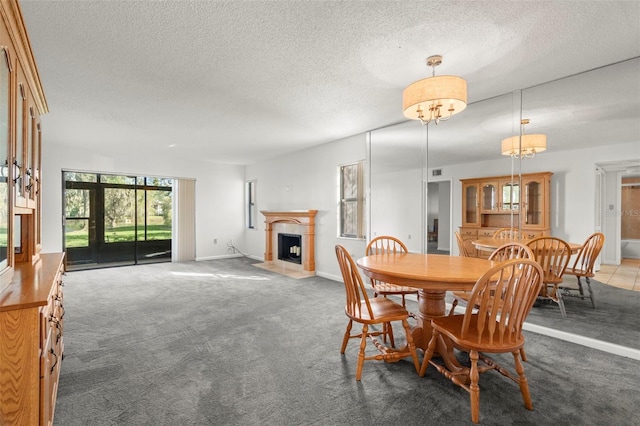 dining area with carpet and a textured ceiling