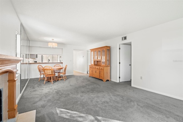 dining space featuring dark colored carpet