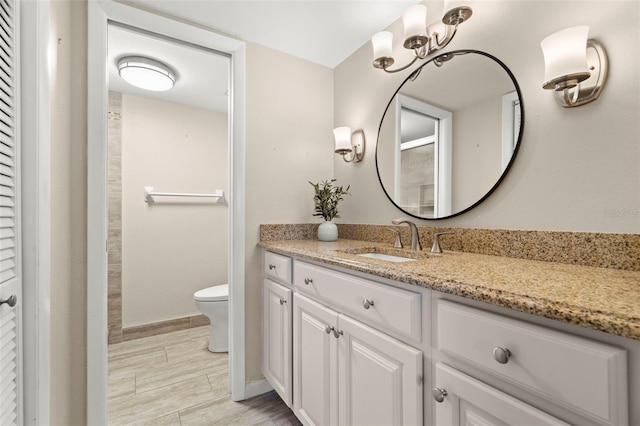 bathroom featuring toilet, hardwood / wood-style flooring, and vanity