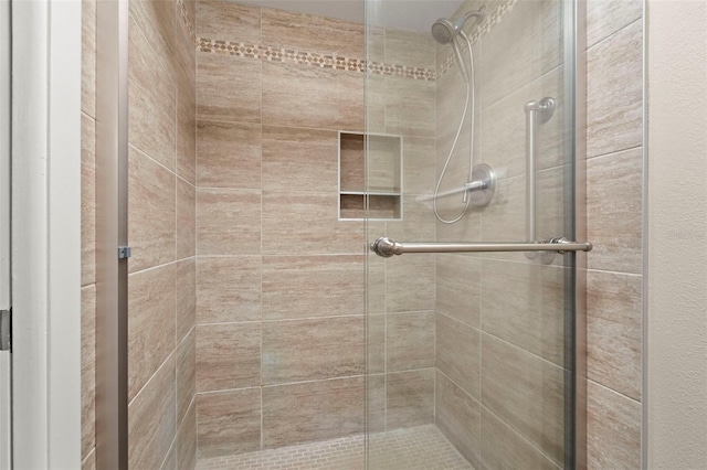 bathroom with a shower with shower door