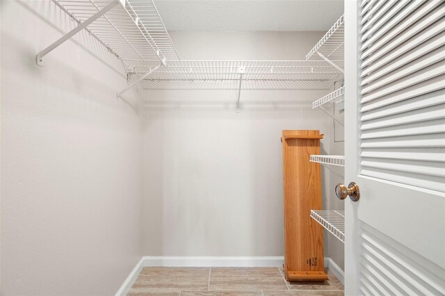 spacious closet featuring hardwood / wood-style flooring