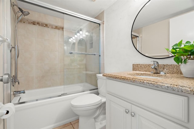 full bathroom with vanity, toilet, tile patterned floors, and bath / shower combo with glass door