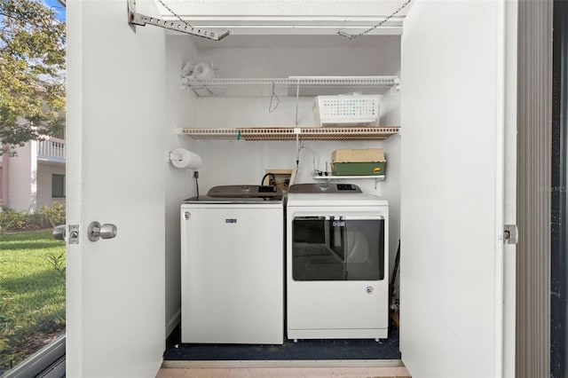 clothes washing area with washer and dryer