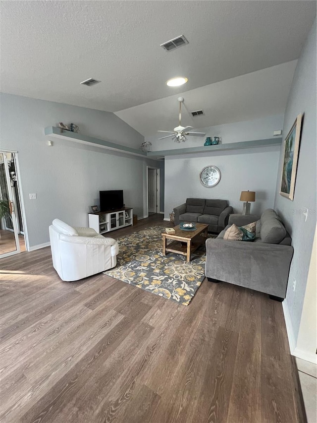 living room with ceiling fan, hardwood / wood-style flooring, and vaulted ceiling