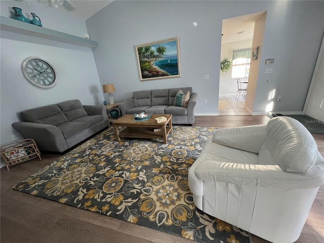 living room featuring lofted ceiling and hardwood / wood-style flooring