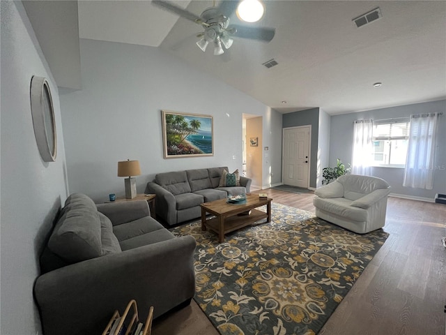 living room with ceiling fan, wood-type flooring, and vaulted ceiling