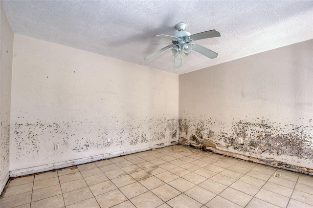 empty room with a textured ceiling and ceiling fan