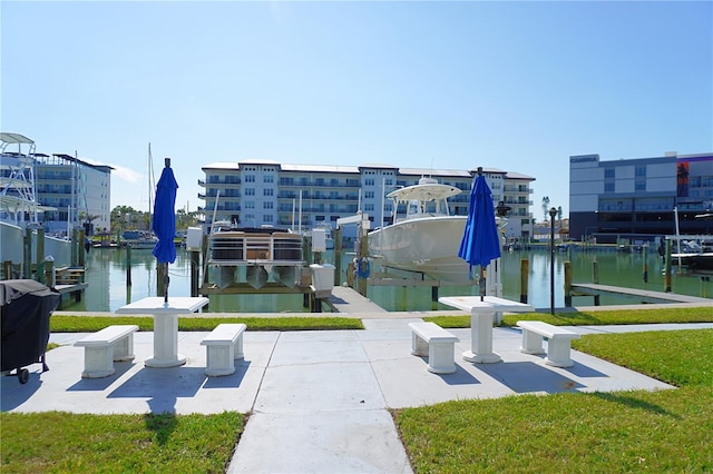 view of home's community featuring a water view, boat lift, and a boat dock