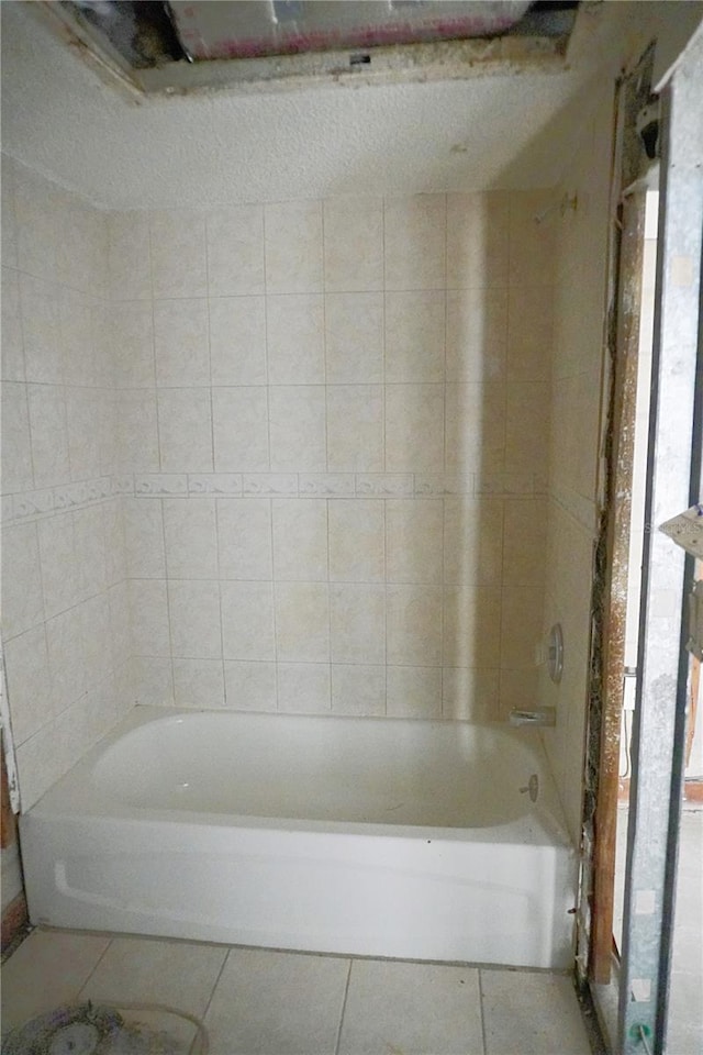 bathroom featuring tile patterned floors and bathing tub / shower combination