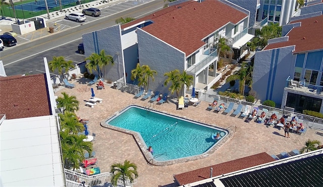 community pool featuring a patio area and fence